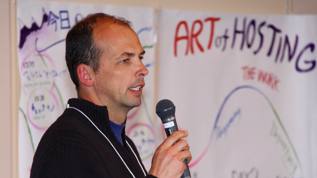 tenneson woolf group process facilitator speaking with microphone in japan art of hosting